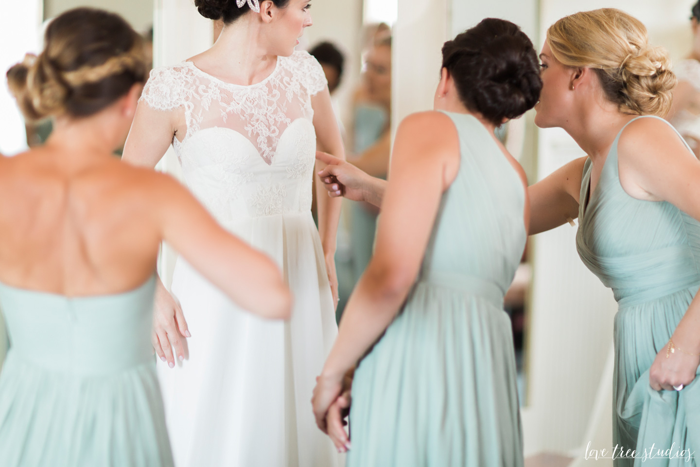 bride putting on wedding dress