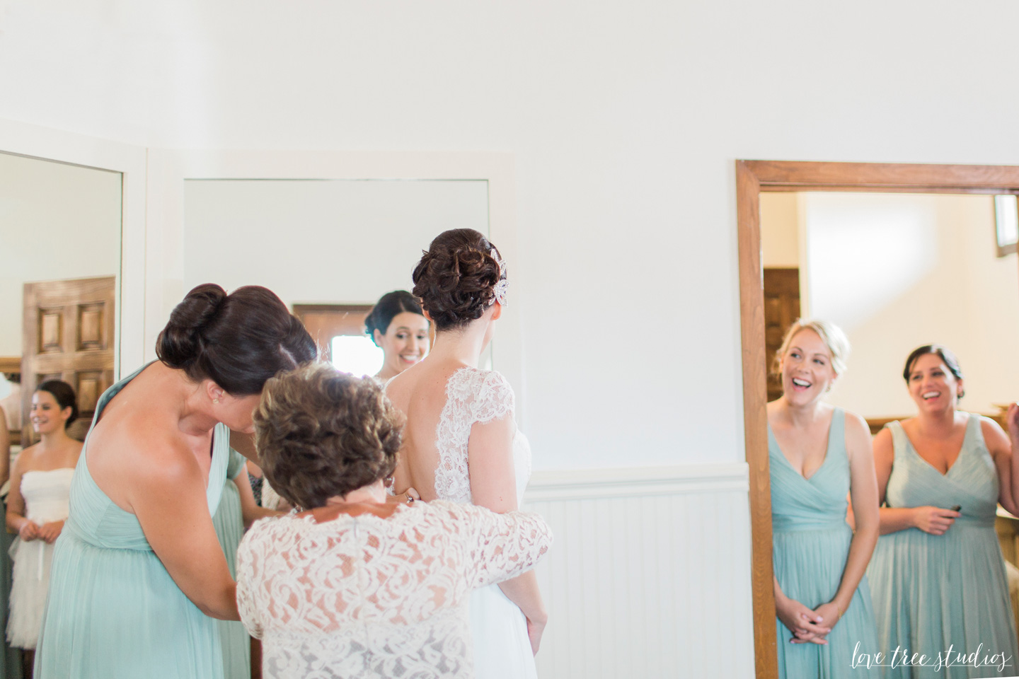 bride putting on wedding dress