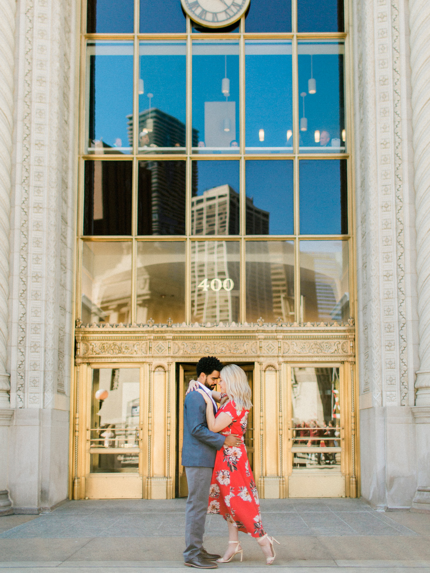 Couple in front of beautiful Chicago building during engagement session by Love Tree Studios.