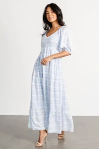 Model is wearing Baltic Born Adalee dress in light blue floral and a great choice for what to wear for your maternity session.