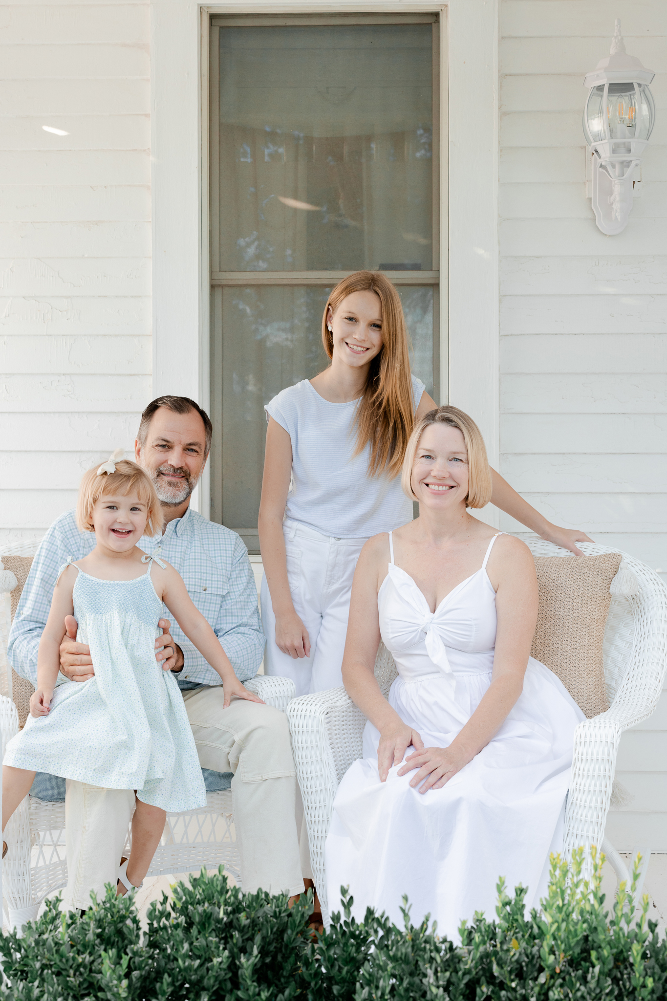 Family sitting together on their farmhouse porch — Love Tree Studios, Missouri family photographer.