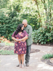 A newly engaged couple laughs during their engagement session at Shelter Gardens in Columbia Missouri by wedding photographer Love Tree Studios.