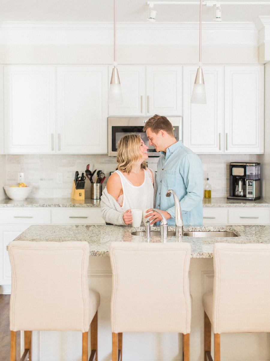 An intimate in-home engagement session in the kitchen by Missouri wedding photographer Love Tree Studios.