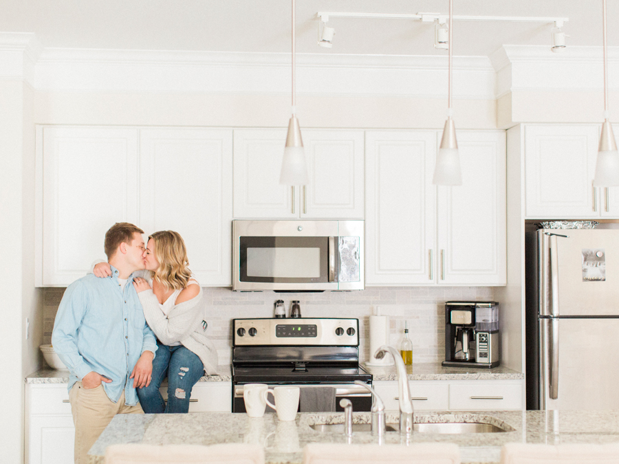 An intimate in-home engagement session in the kitchen by Missouri wedding photographer Love Tree Studios.