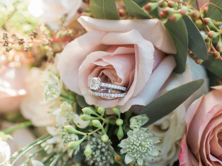 A beautiful arrangement of wedding rings on the bridal bouquet taken by Love Tree Studios during and intimate courthouse wedding.