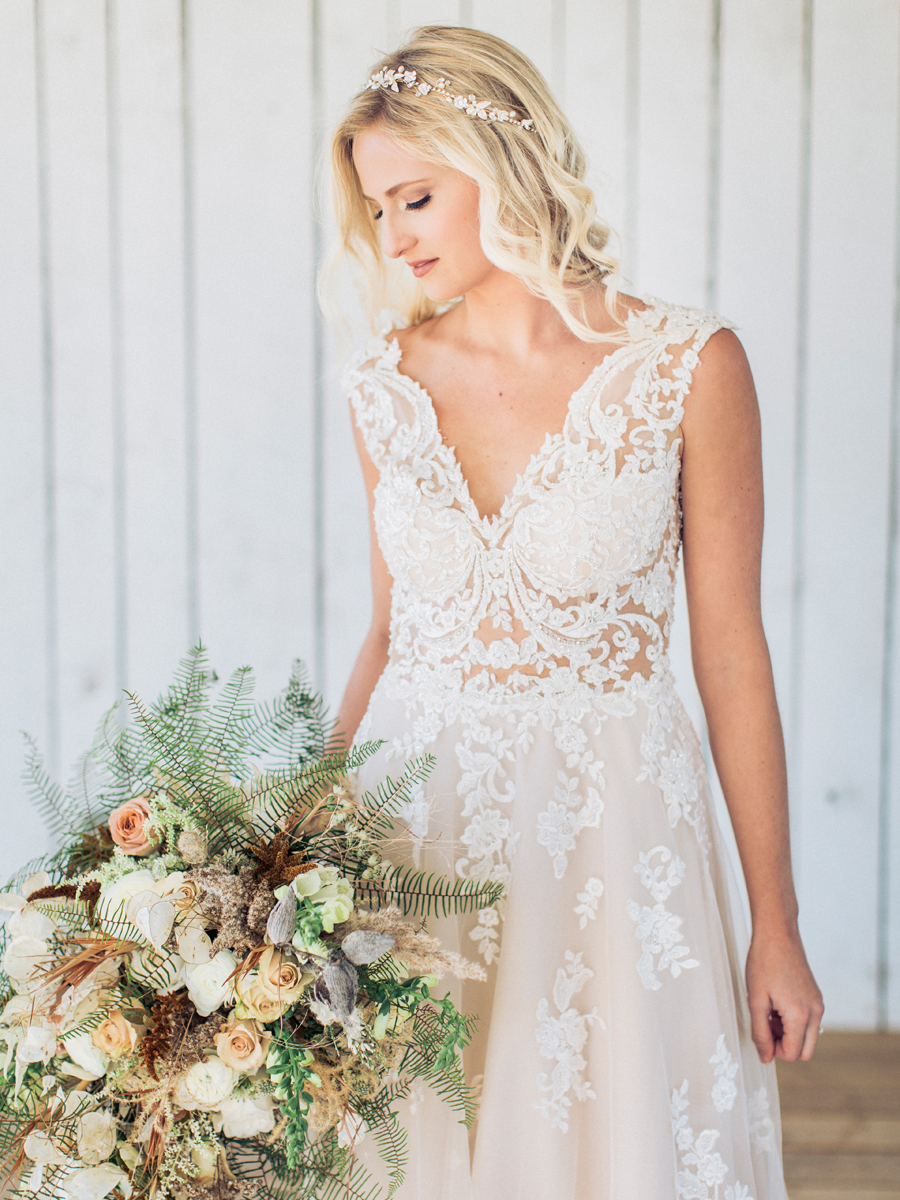 A bride wears a Morilee dress from Breeze Bridal Boutique at her Missouri wedding photographed by Love Tree Studios.