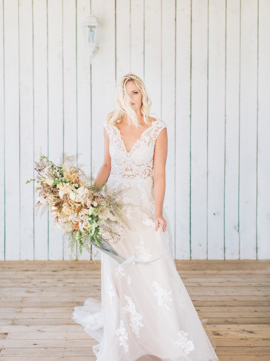 A bride wears a Morilee dress from Breeze Bridal Boutique at her Missouri wedding photographed by Love Tree Studios.