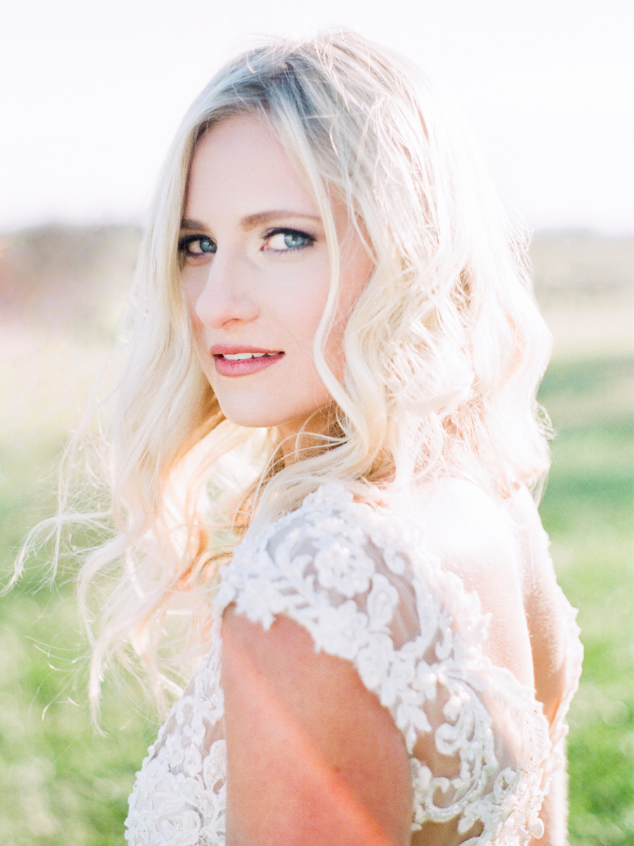 A bride looks at the camera at her Missouri wedding at Blue Bell Farm by photographer Love Tree Studios.