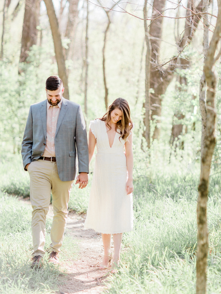 During their Capen Park engagement session, Love Tree Studios captures the couple walking hand in hand in Columbia, Missouri.