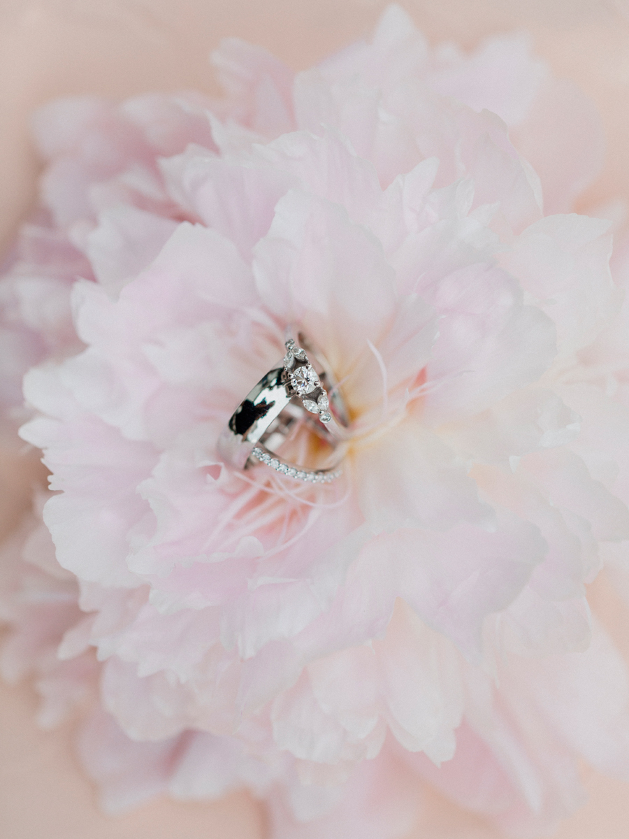 Wedding rings set in a pink carnation by Love Tree Studios at Blue Bell Farm.