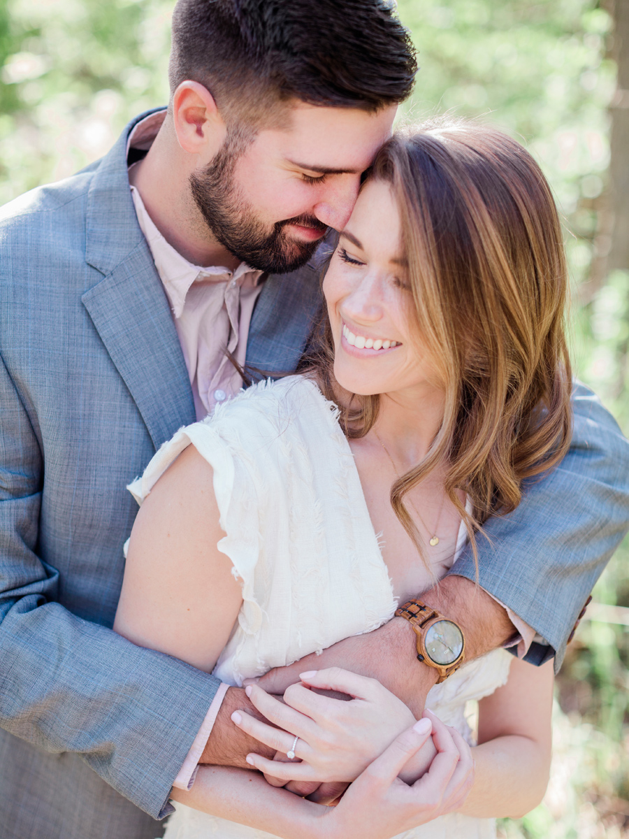The groom hugs the bride during their Capen Park engagement session with wedding photographer Love Tree Studios in Columbia, MO.