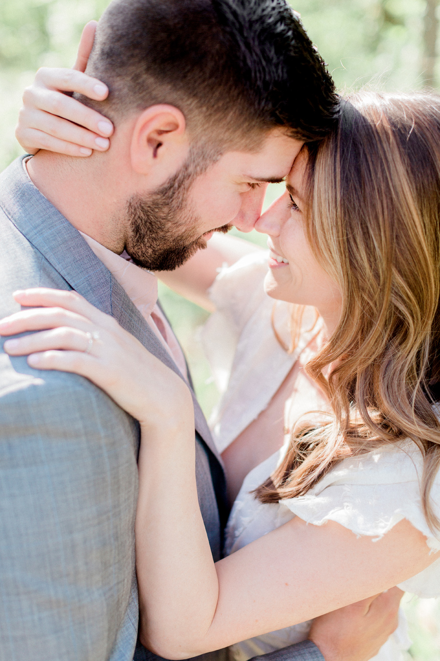 A sweet embrace at Capen Park during their engagement session by Missouri wedding photographer Love Tree Studios.