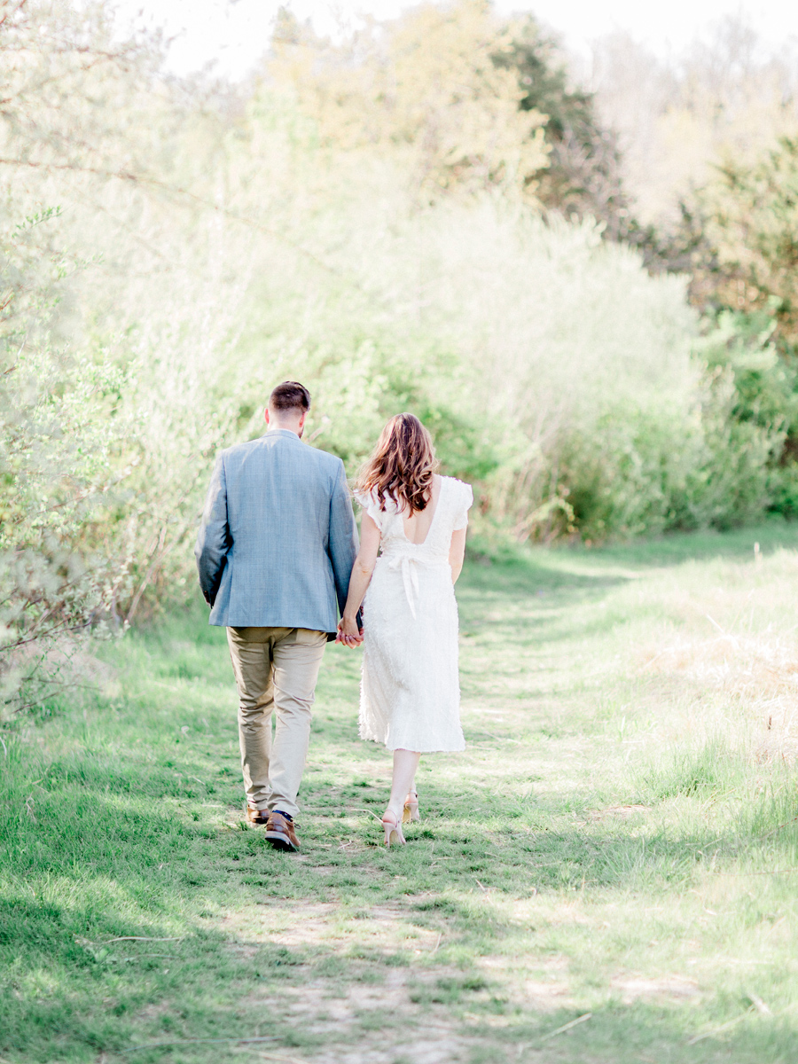 During their Capen Park engagement session, Love Tree Studios captures the couple walking hand in hand in Columbia, Missouri.