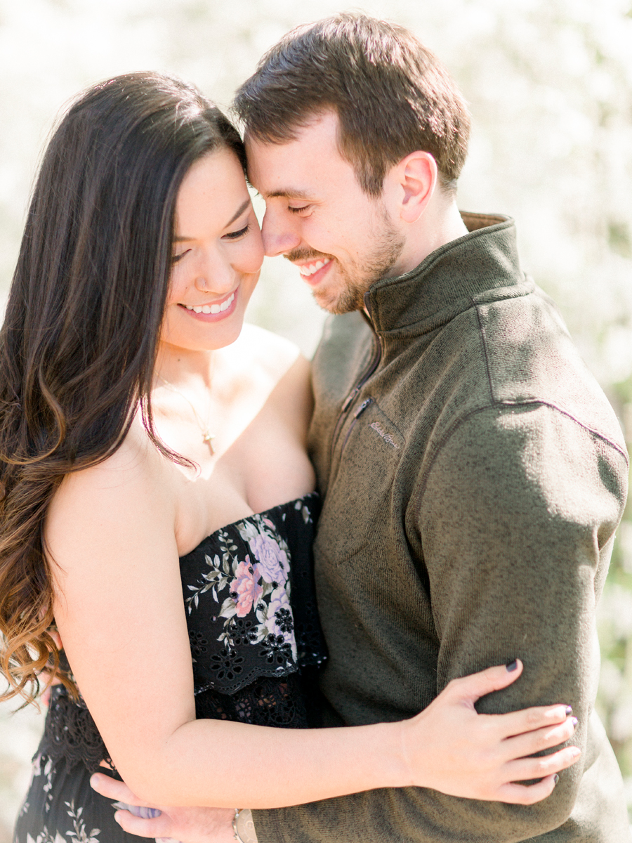 During their Columbia Missouri engagement session, the couple poses with their frenchie.