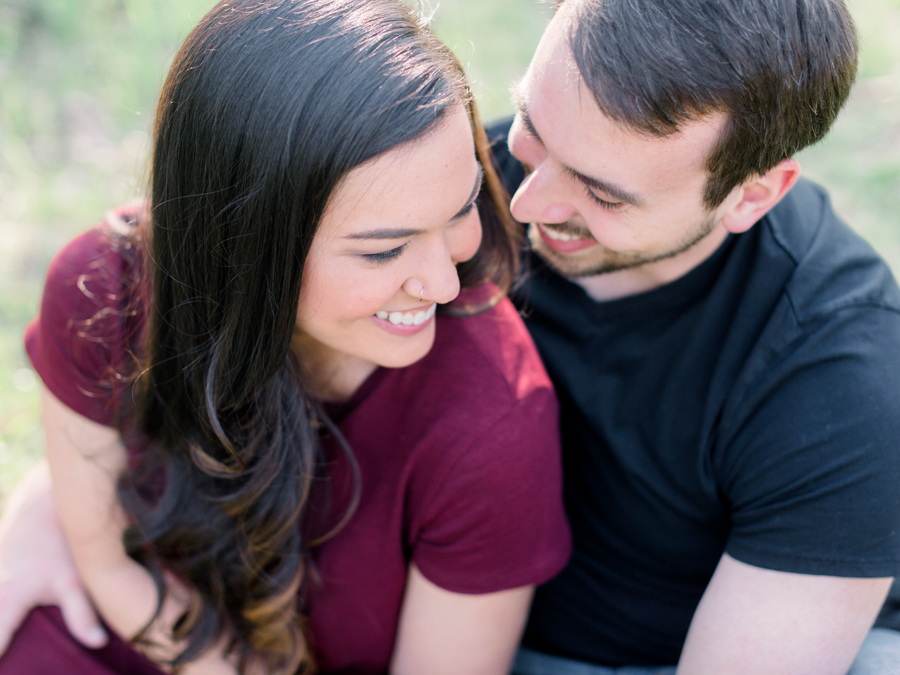 A couple embraces during their Columbia Missouri engagement session with photographer Love Tree Studios.