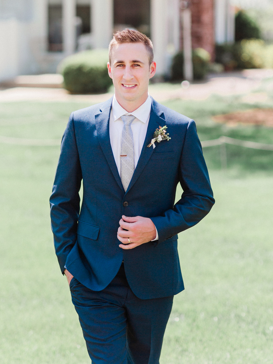 A groom poses for his portrait at his Columbia Missouri wedding by midwest wedding photographer love tree studios.