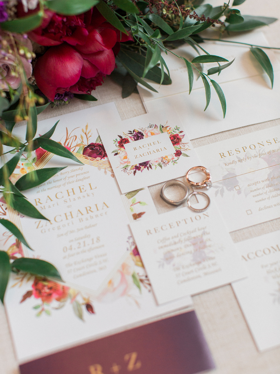 A wedding invitation suite by The Ink Cafe with wedding rings and bouquet photographed by Love Tree Studios for a camdenton missouri wedding.