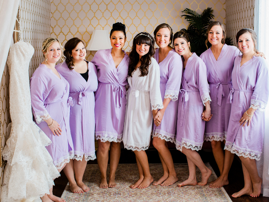 A bride and her bridesmaids pose for Love Tree Studios at a camdenton missouri wedding at The Exchange Venue.