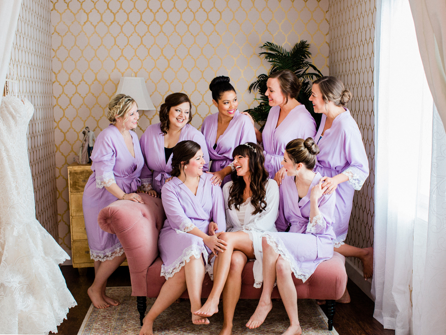 A bride and her bridesmaids pose for Love Tree Studios at a camdenton missouri wedding at The Exchange Venue.
