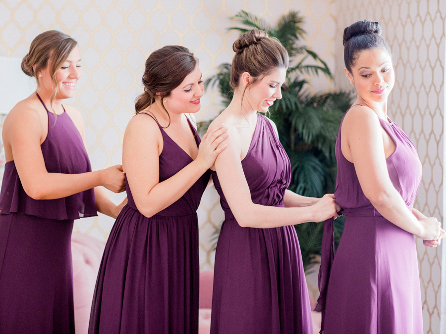Bridesmaids get ready for the wedding while being photographed by Missouri wedding photographer Love Tree Studios at a Camdenton Missouri wedding.