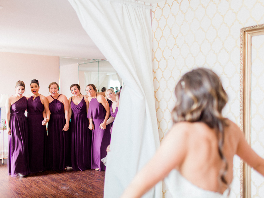 Missouri wedding photographer Love Tree Studios captures the bridesmaid's reactions to see in the bride for the first time at her Camdenton Missouri wedding.
