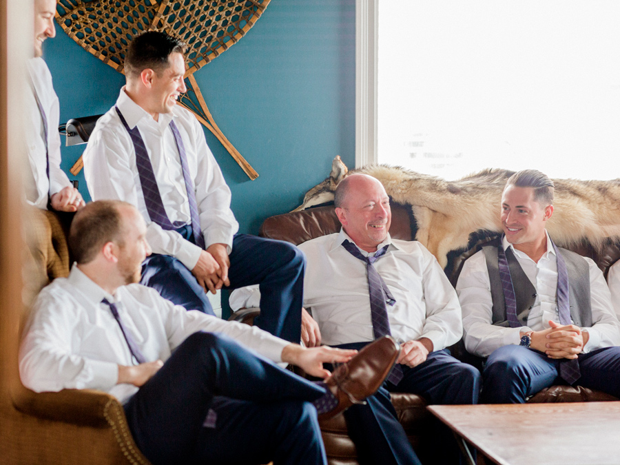 Love Tree Studios photographs the groom hanging out with his groomsmen at The Exchange Venue at his Camdenton Missouri wedding.