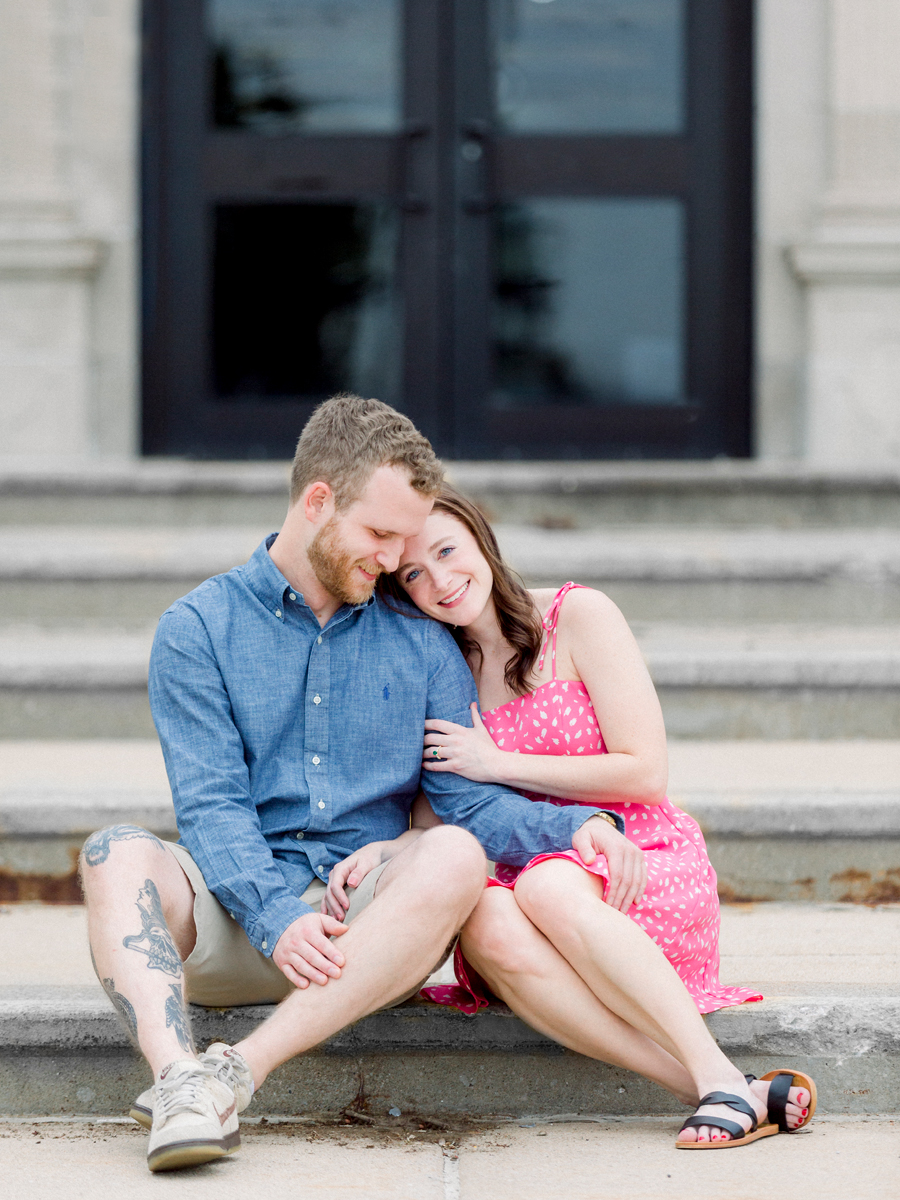 A couple snuggles on the steps of the high school where they met in Columbia, Missouri.
