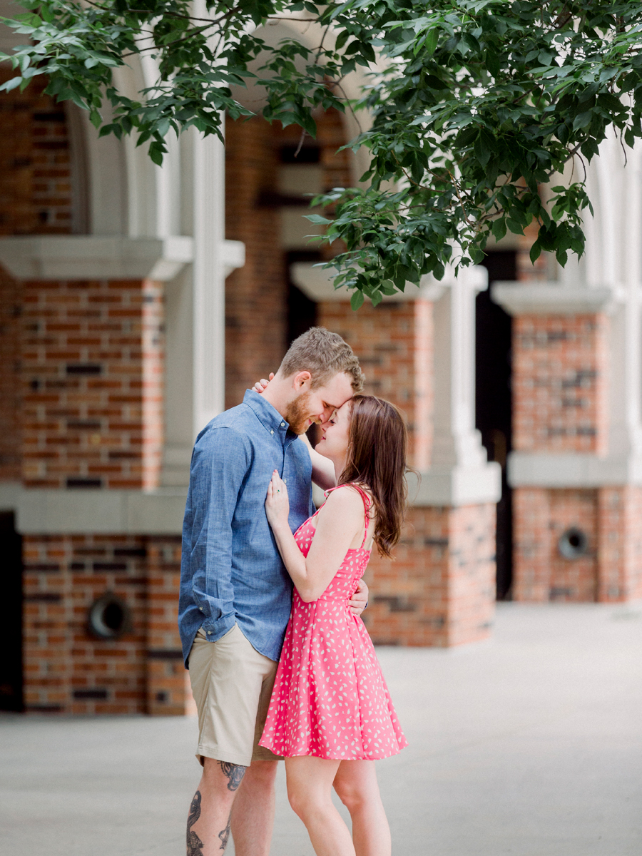 Slow dancing in front of the spot where they met, a couple poses for their engagement photos in Columbia, Missouri.