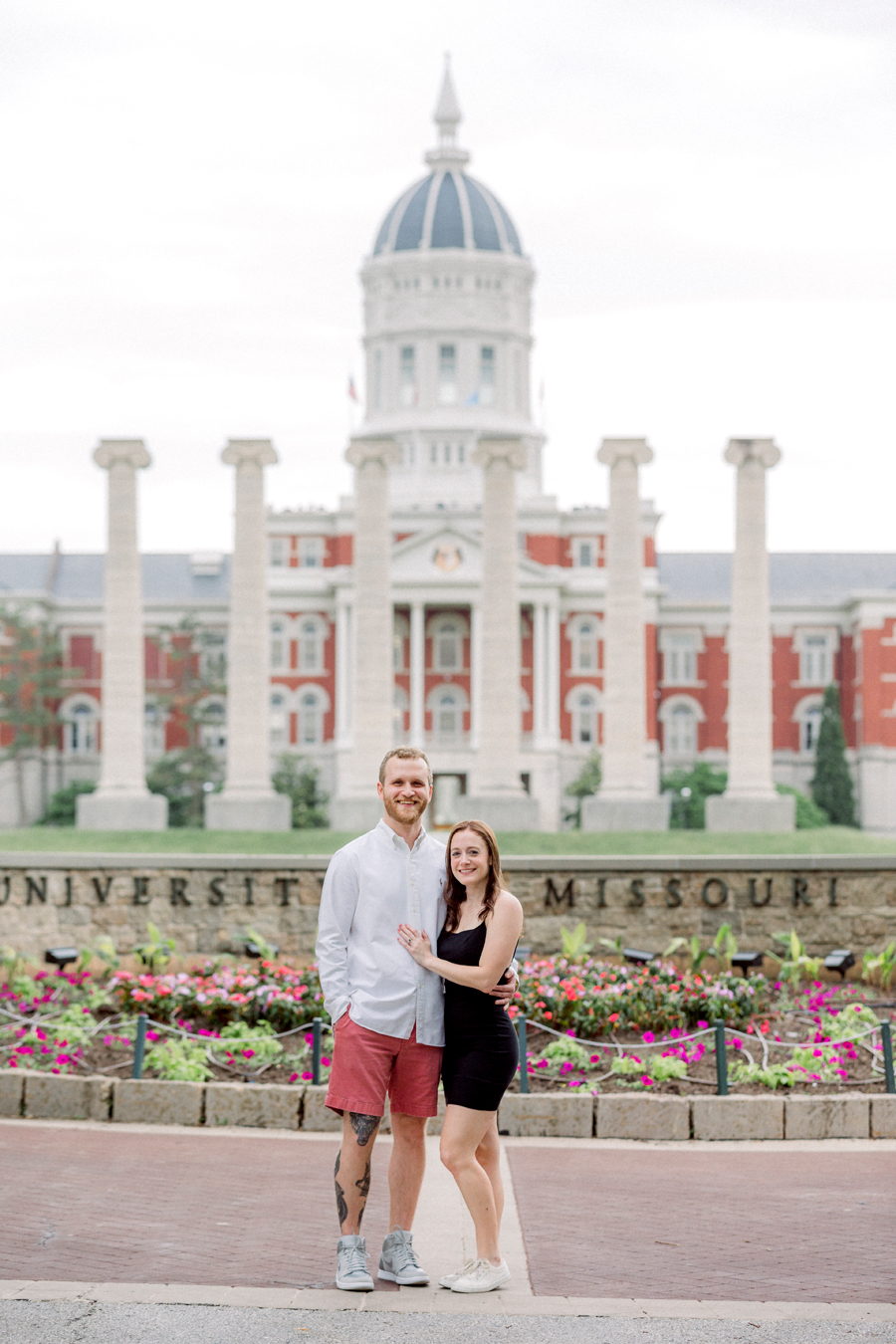 A couple poses for their engagement photos in front of the Quad at Mizzou.