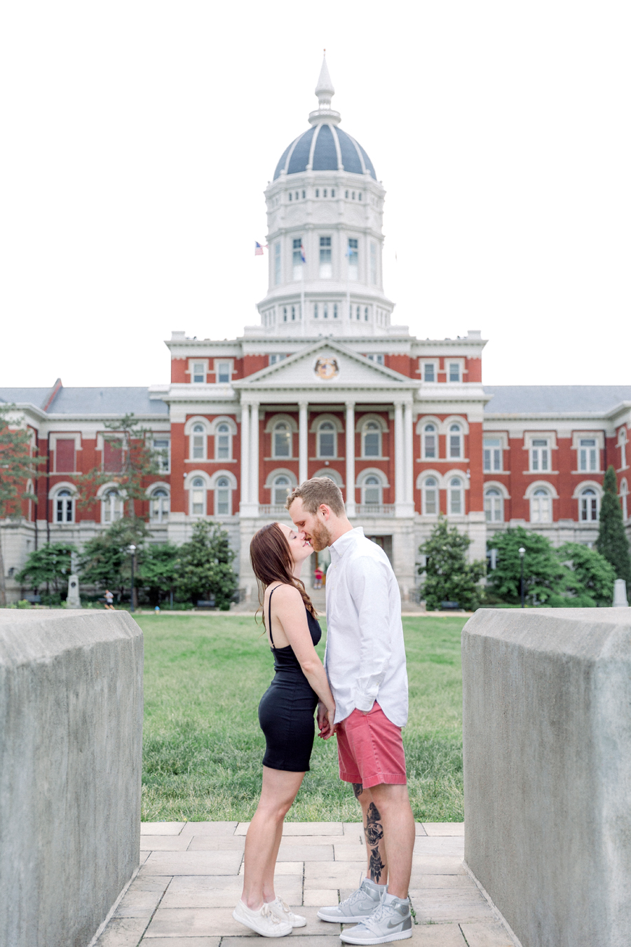 A couple kisses in front of Jesse Hall during their Columbia, Missouri engagement session.