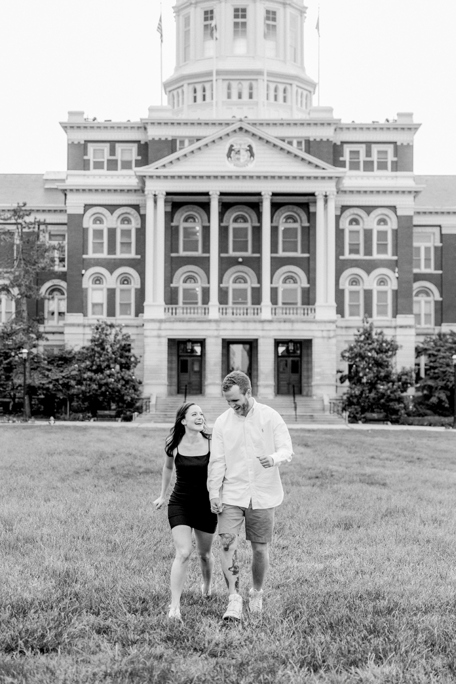 A couple laughs and runs toward the camera for their Mizzou engagement session.