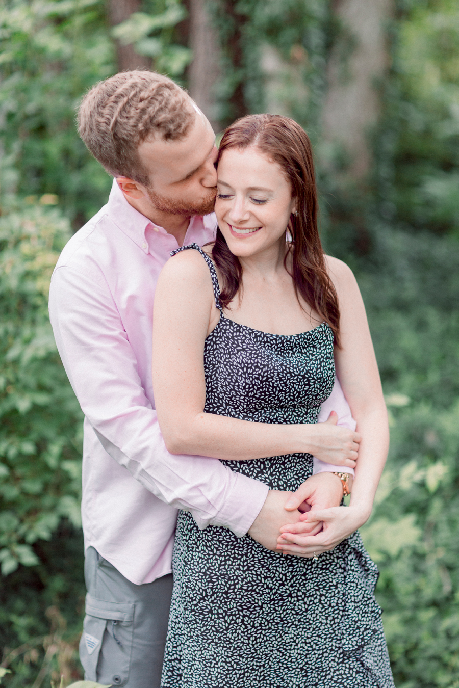 A couple embraces on the MKT trail during their Columbia, MO engagement session.