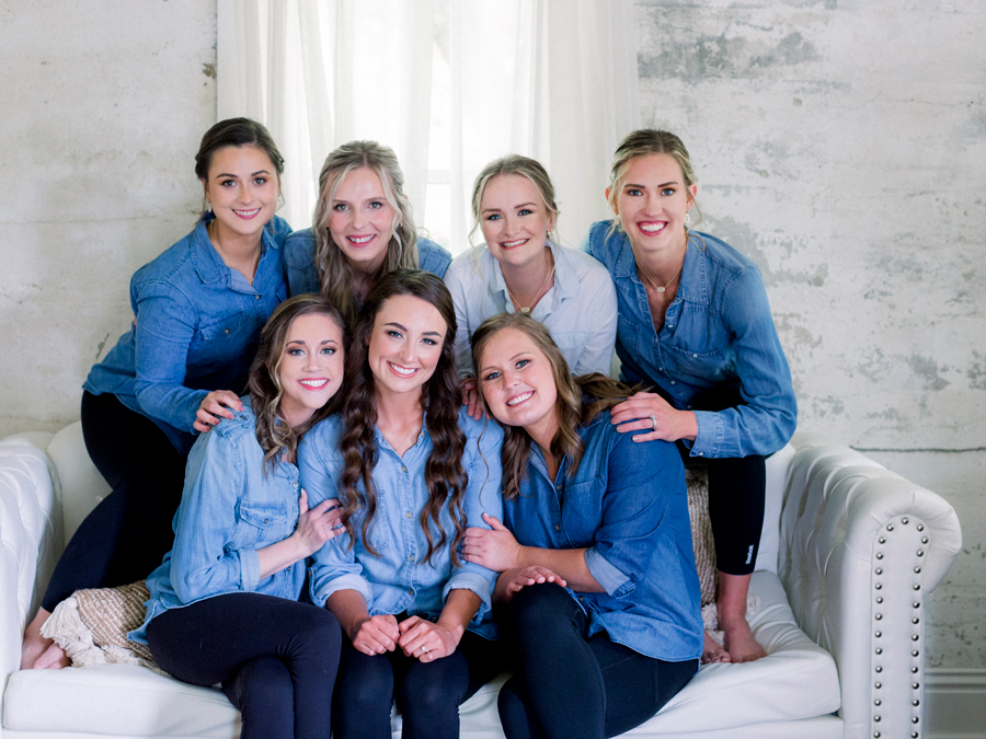 The bride and her bridesmaids pose for a casual photo at a wedding in Blackwater, Missouri.