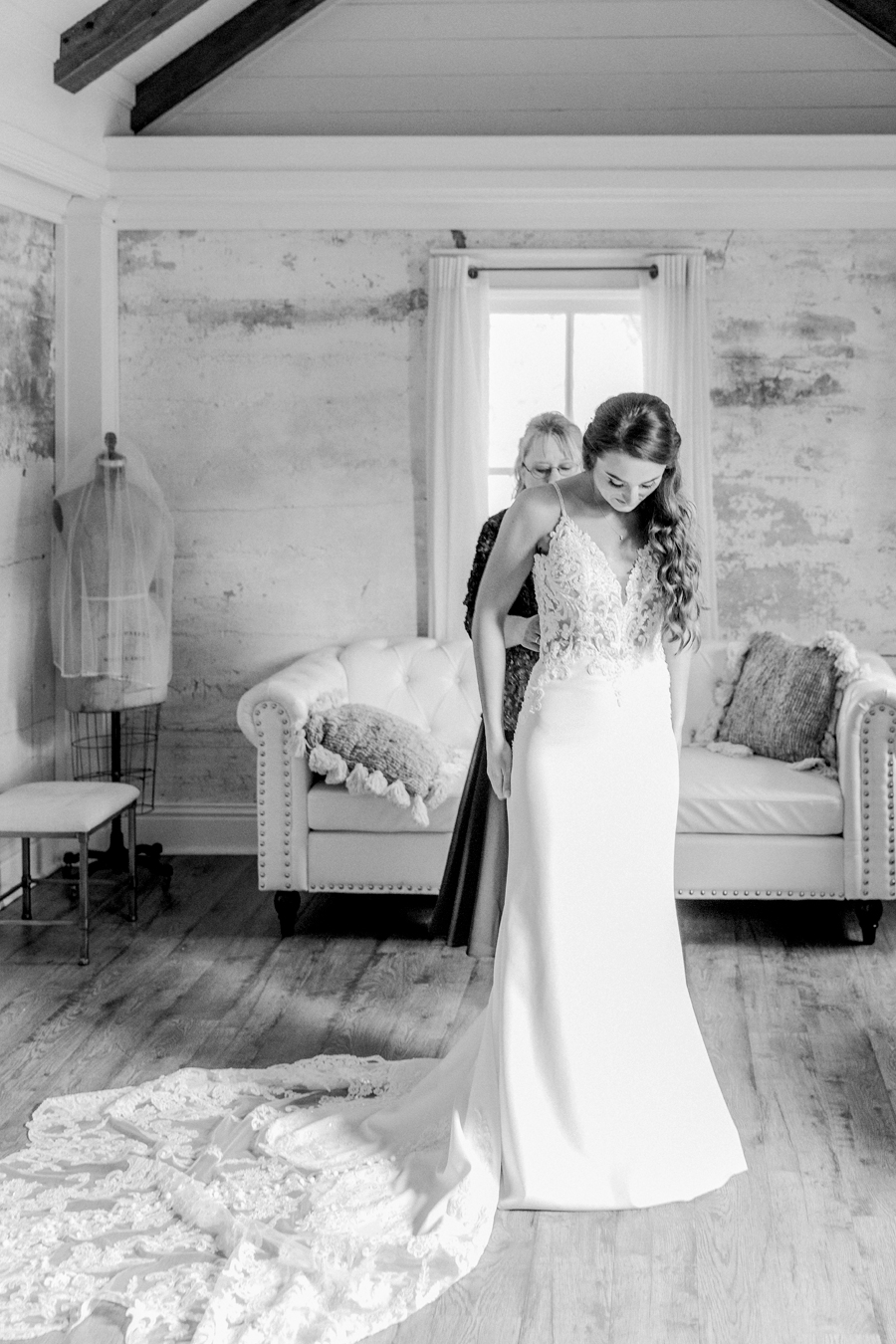 The bride puts her dress on in the bridal cottage at Wildcliff Weddings and Events.