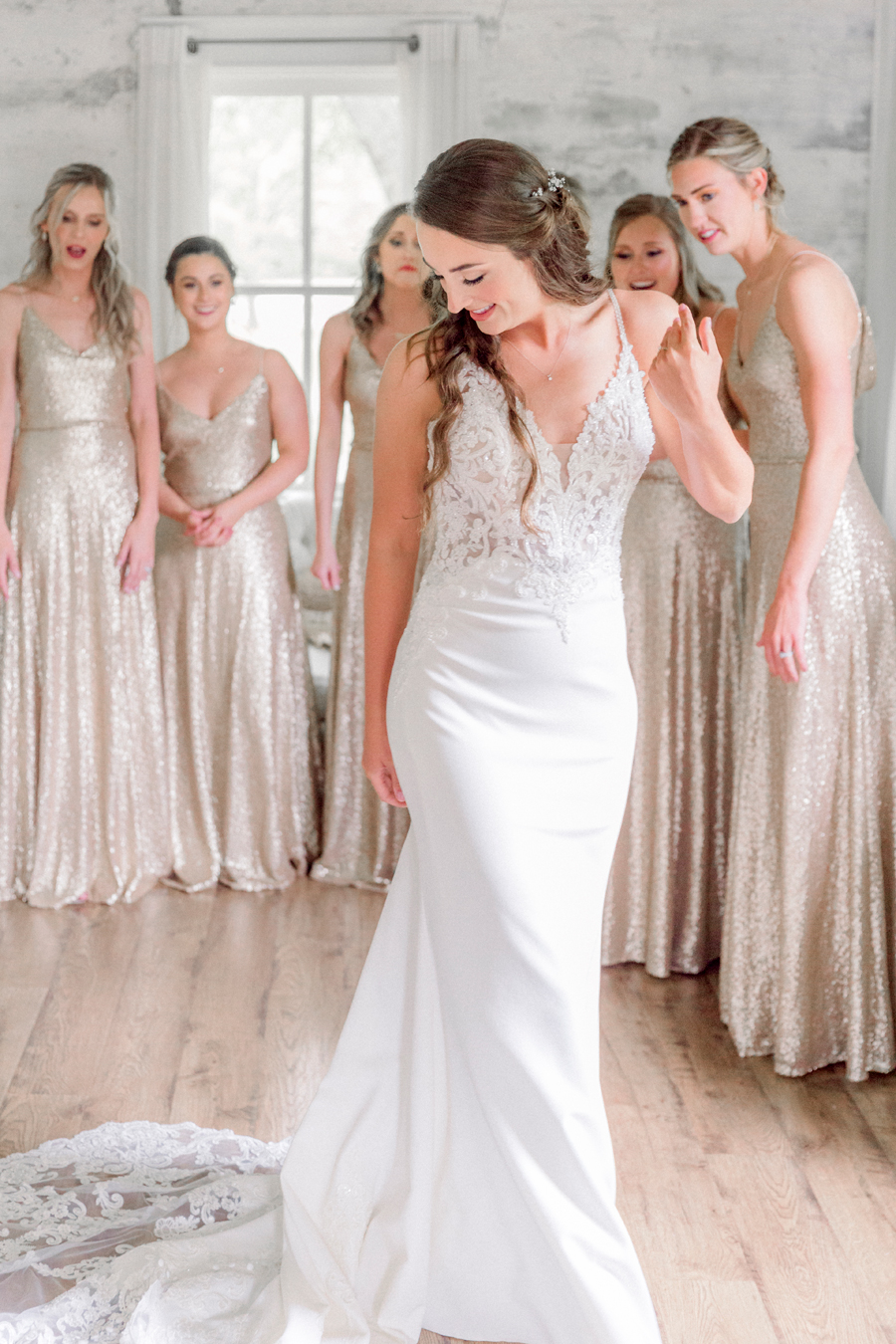 A bride does a first look with her bridesmaids at Wildcliff Weddings and Events.