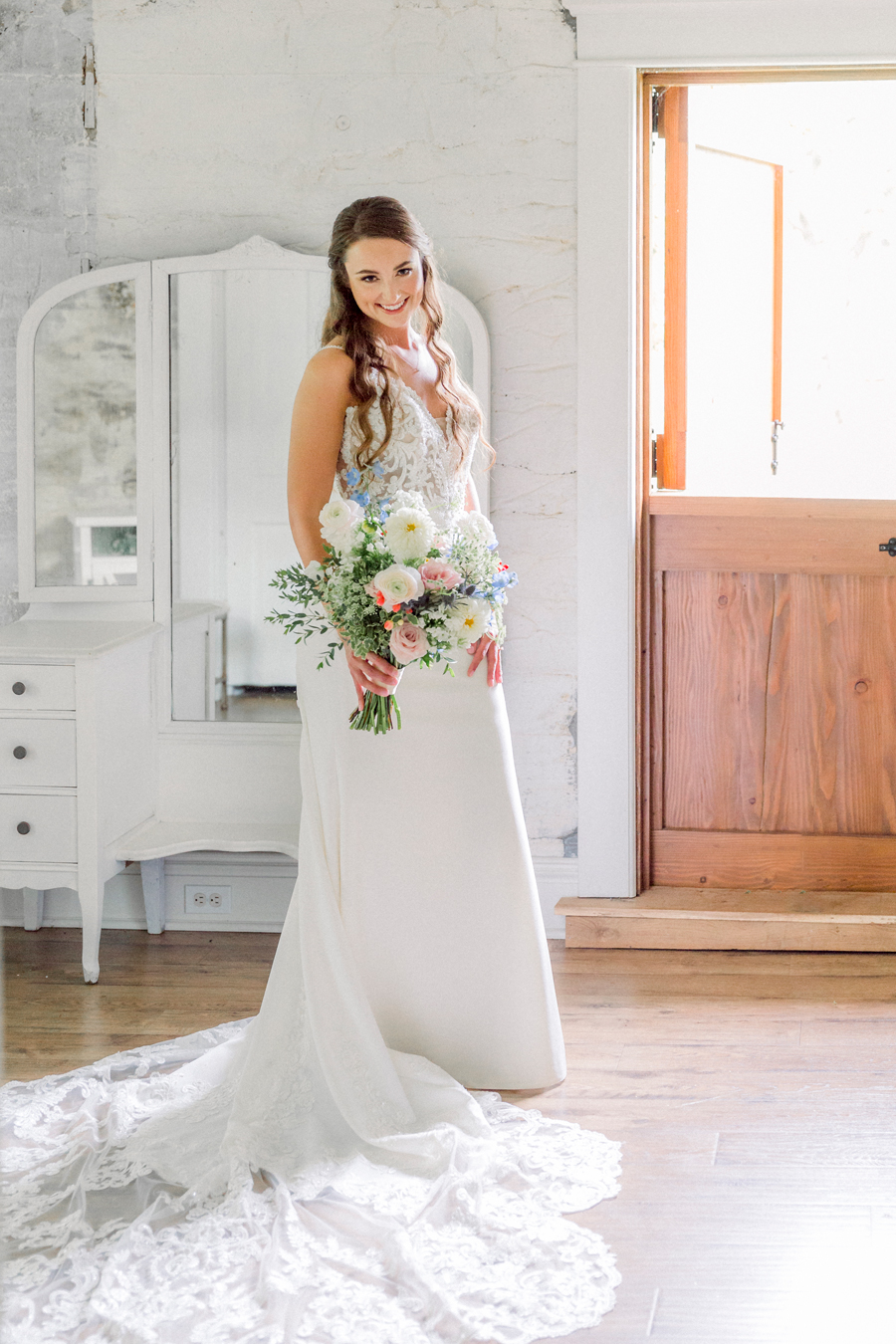 A bride takes a portrait in the bridal cottage of Wildcliff Wedding and events.