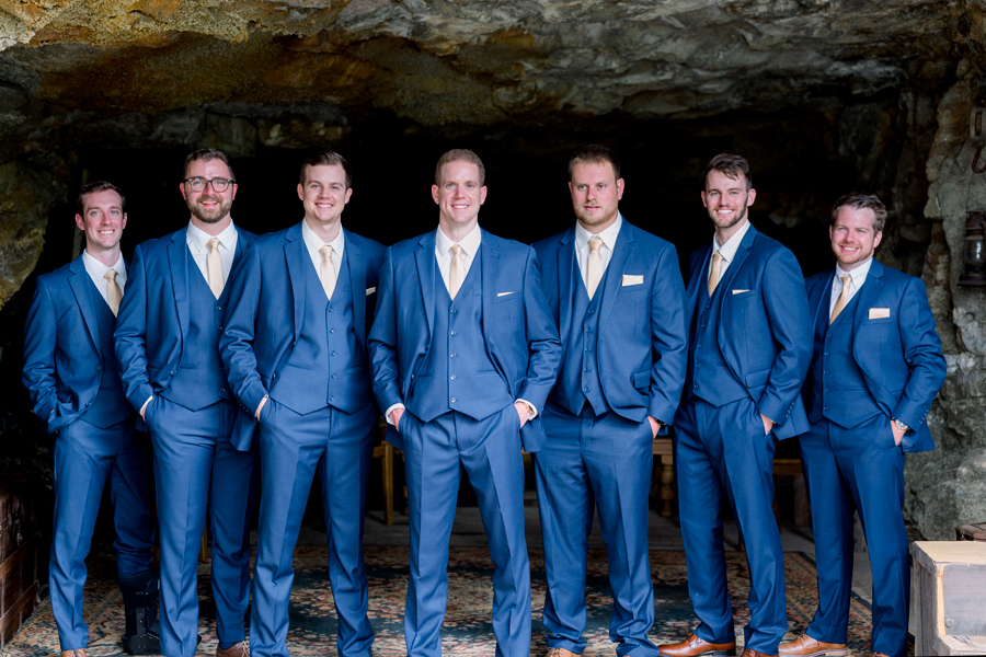 A groom poses with his groomsmen in the cave at Wildcliff Weddings and Events in Blackwater, Missouri.