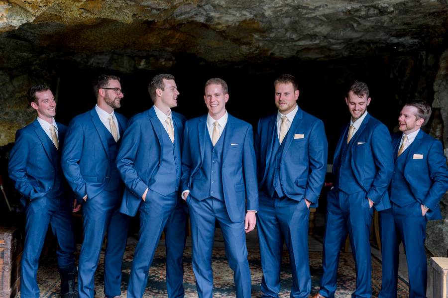A groom poses with his groomsmen in the cave at Wildcliff Weddings and Events in Blackwater, Missouri.