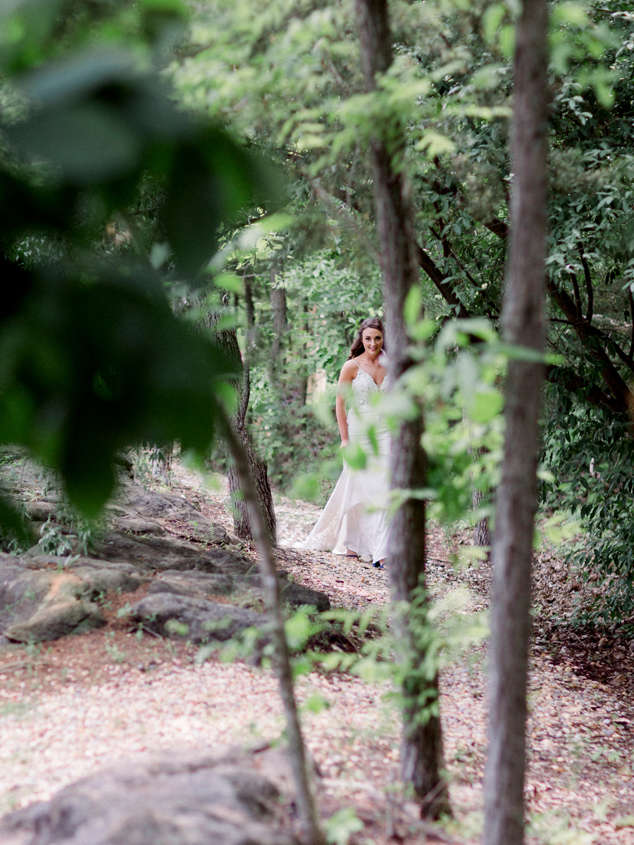 A bride walks up a path to her groom for a wedding at Wildcliff Weddings and Events.
