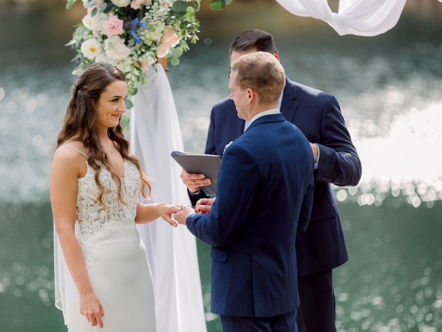 A bride and groom exchange vows on the water at Wildcliff Weddings and Events in Blackwater, Missouri.