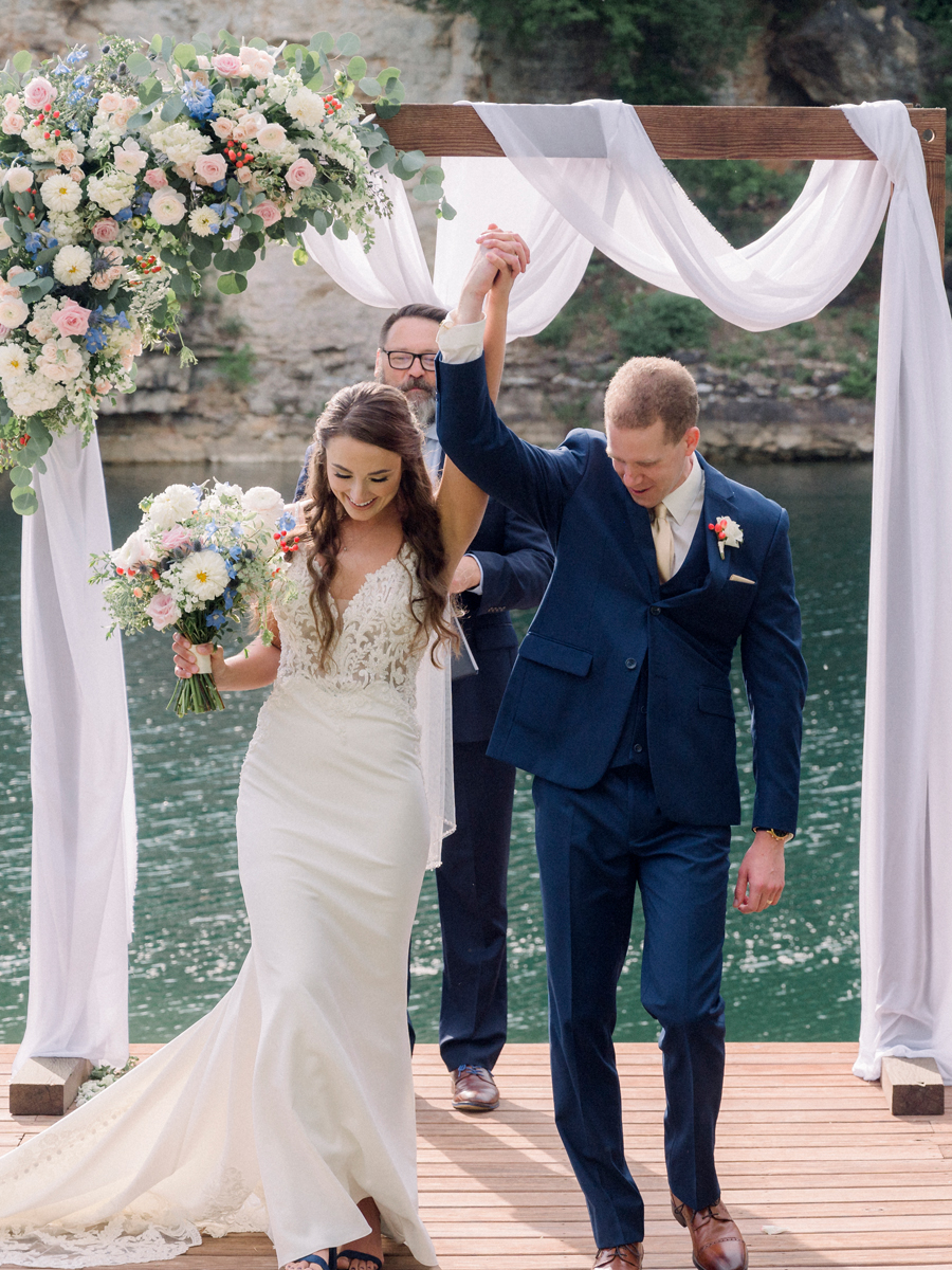 A bride and groom exchange vows on the water at Wildcliff Weddings and Events in Blackwater, Missouri.