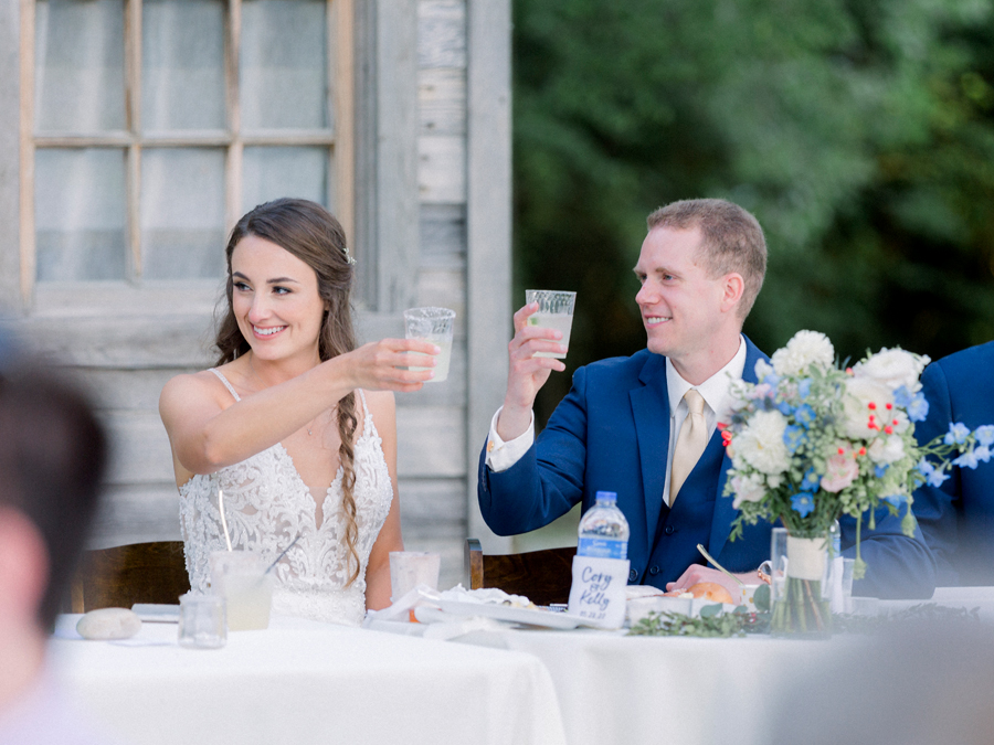 Guests looks on as toasts are given during an outdoor Missouri wedding at Wildcliff Weddings and Events.