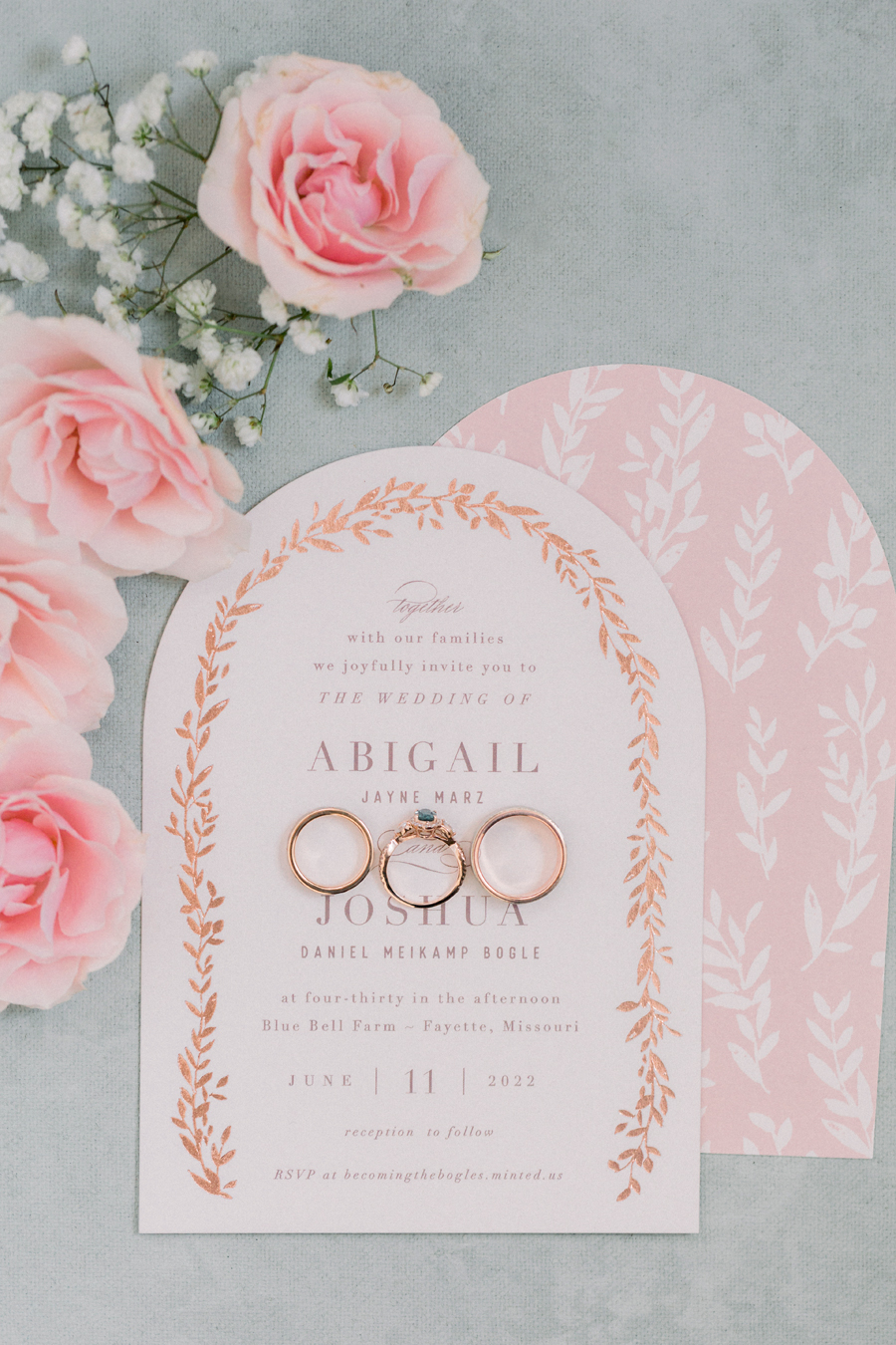 The wedding invitation suite with the couple's rings on it at a Blue Bell Farm wedding by Love Tree Studios.