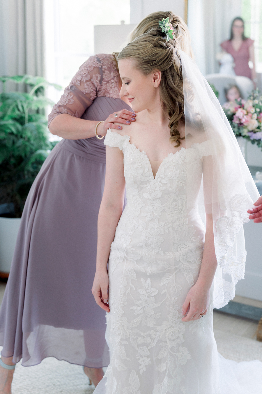 The bride's mother adjusts her veil at a Blue Bell Farm wedding by Love Tree Studios.