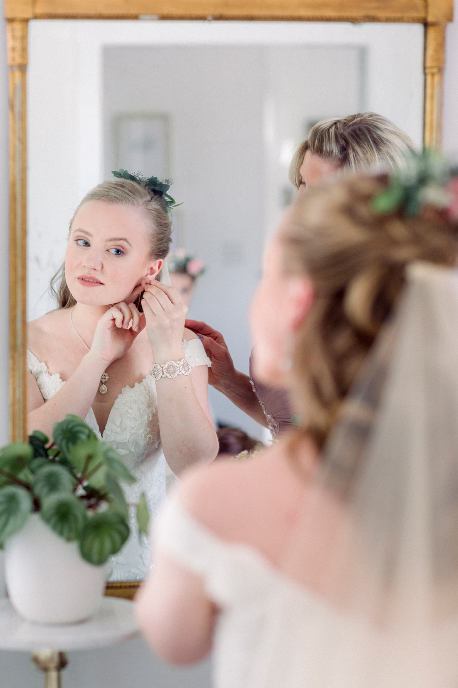The bride puts her jewelry on at a Blue Bell Farm wedding by Love Tree Studios.