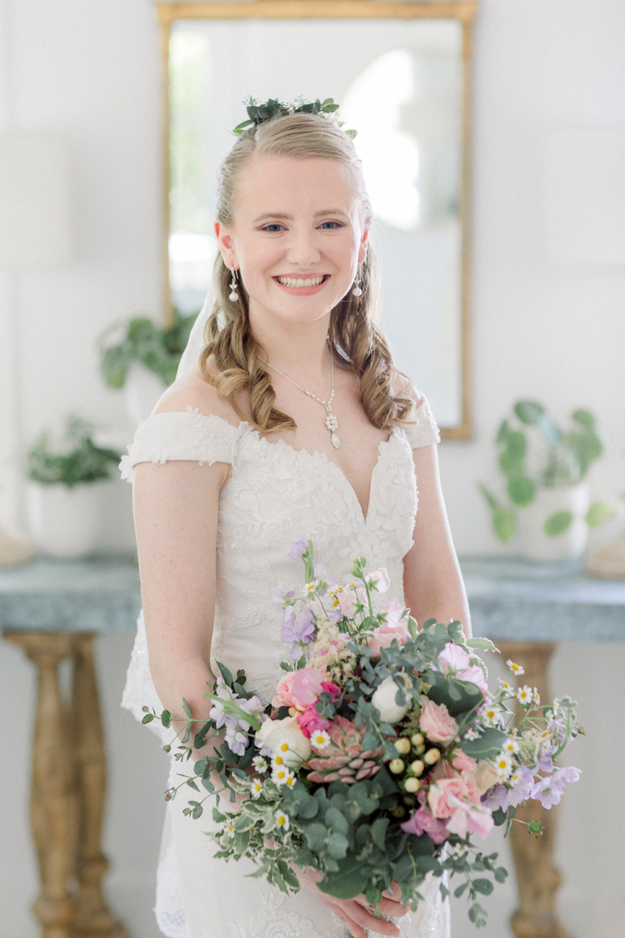 A bride poses for a portrait in the bridal cottage at a Blue Bell Farm wedding by Love Tree Studios.