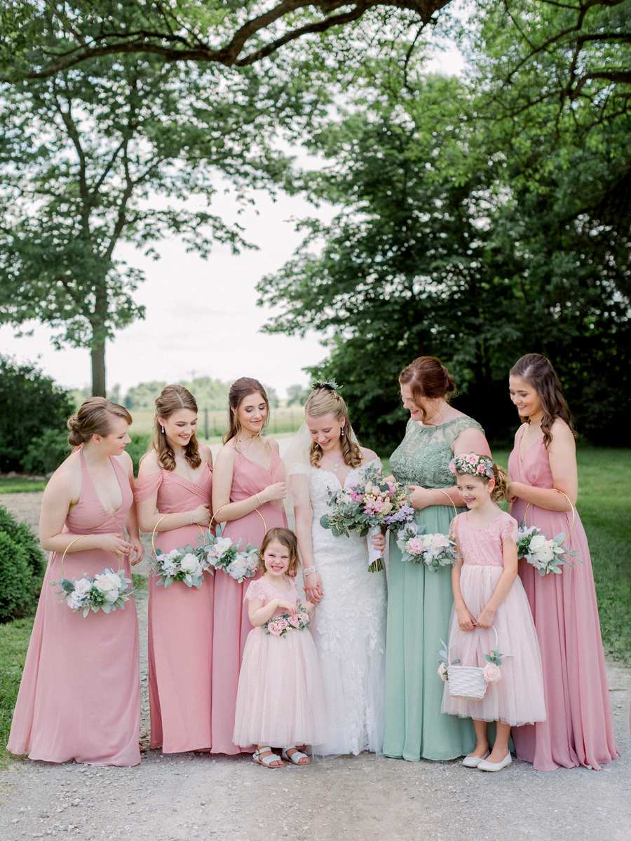 The bridesmaids smile at the flower girl at a Blue Bell Farm wedding by Love Tree Studios.