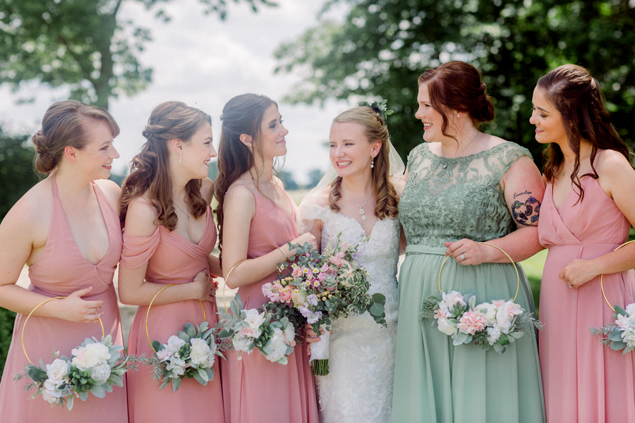 The bride laughs with her bridesmaids at a Blue Bell Farm wedding by Love Tree Studios.