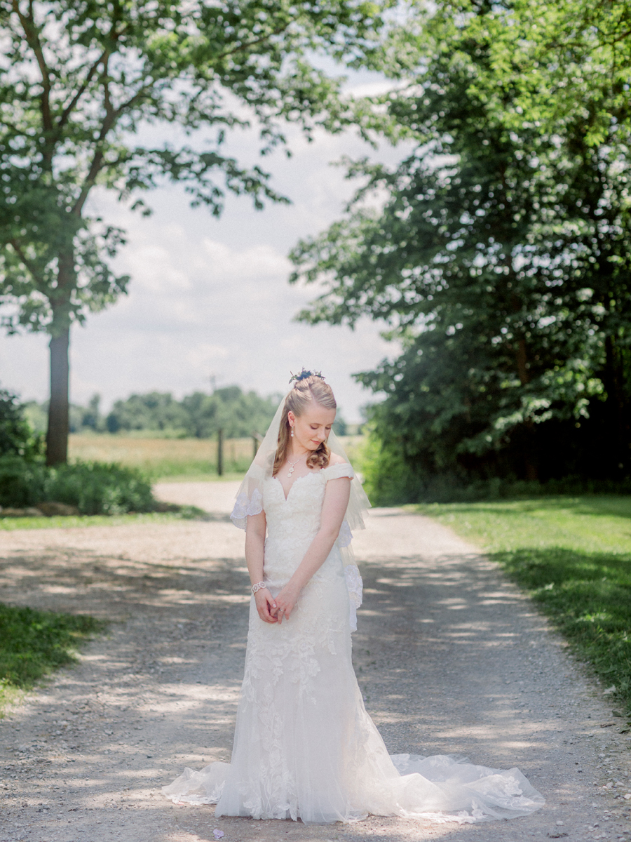 The bride poses for a portrait at a Blue Bell Farm wedding by Love Tree Studios.