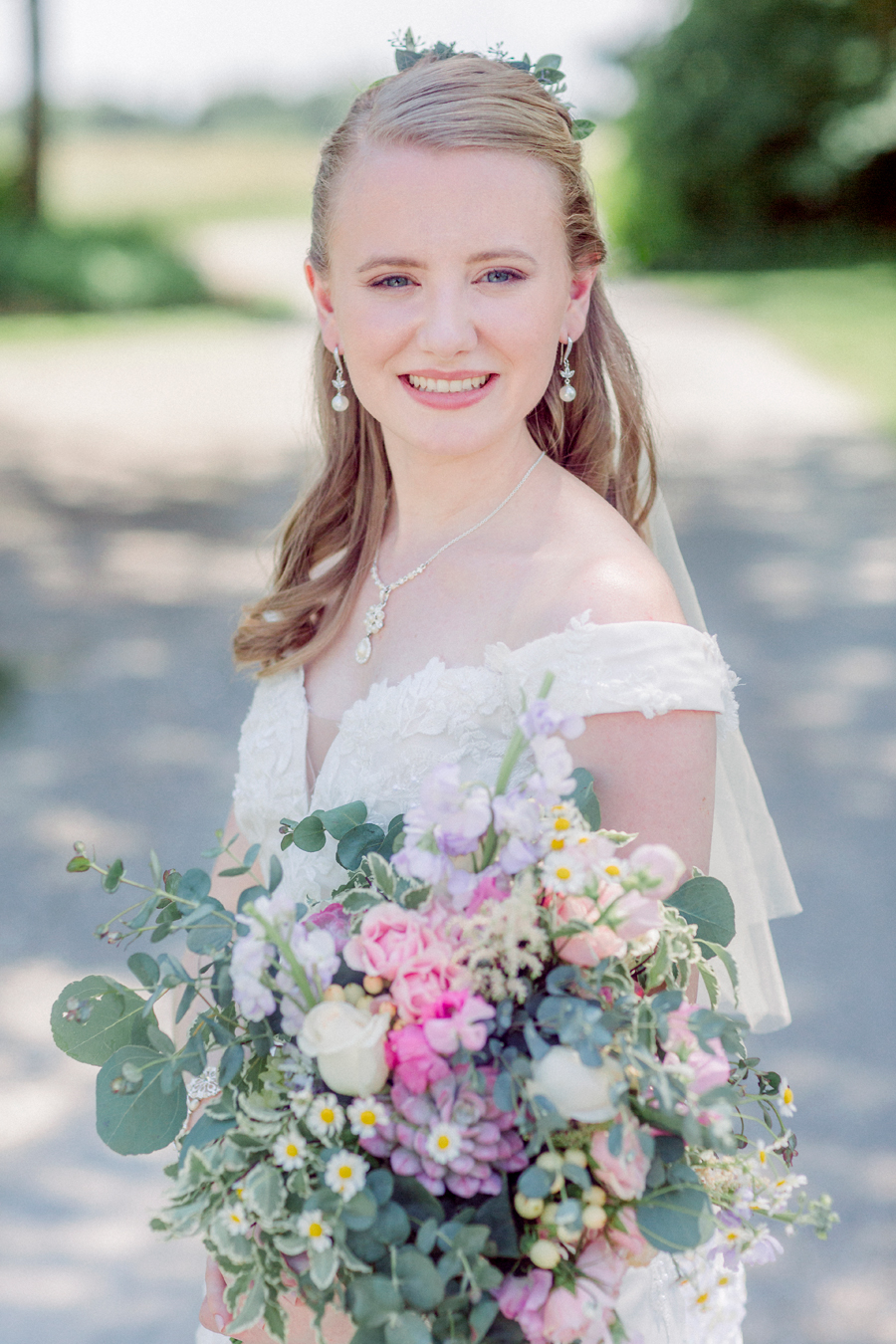 The bride smiles at the camera at a Blue Bell Farm wedding by Love Tree Studios.